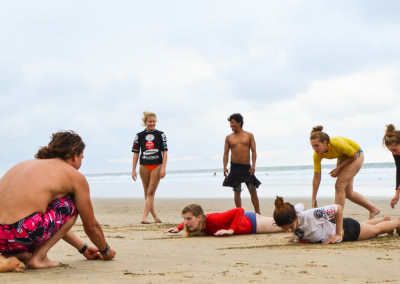 Group learning how to surf on beach