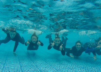 group of people underwater in a pool